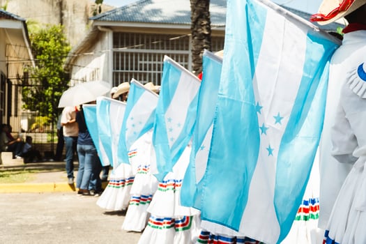 Honduran people celebrating independence day waving flags in traditional clothes photo