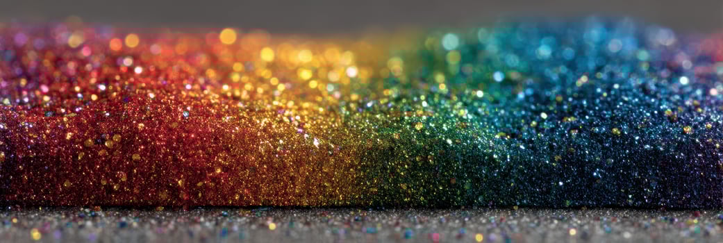 Vibrant rainbow glitter shimmers in light at a creative workspace during the afternoon photo