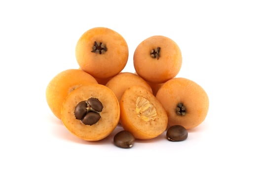 Loquat fruits and seeds showing pulp and peel isolated on white background photo