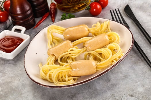 A plate of spaghetti with sauce and ketchup photo