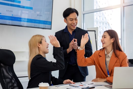 Celebrating Team Success. Professionals high-fiving after achieving business goals. photo