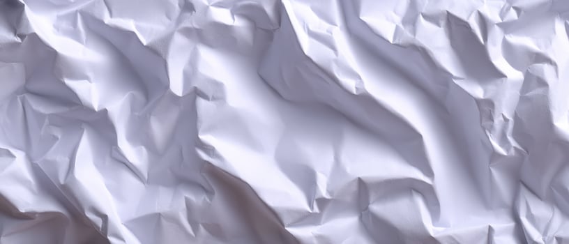 Crumpled white paper close-up texture studio setting abstract photography soft lighting photo