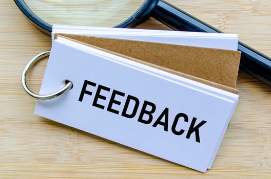 Feedback text on notepad reflecting employee opinions and workplace improvement strategies photo