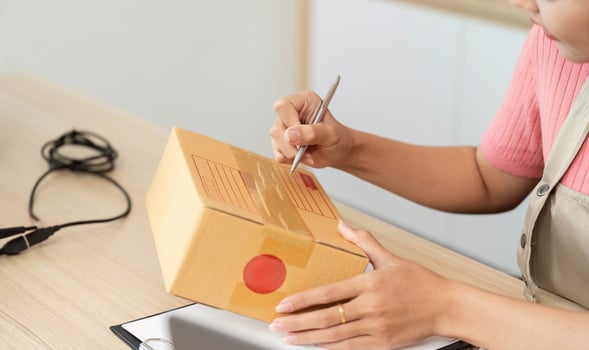Small Business Shipping. Entrepreneur labeling packages for delivery. photo