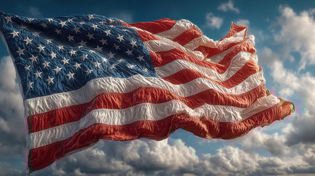 Waving American flag against blue sky with fluffy clouds during bright afternoon photo