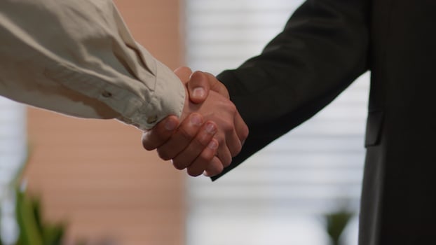 Business handshaking in office close up two businessmen shaking hands indoors company success deal welcome hiring African American diversity unrecognizable men colleagues partners greeting contract photo