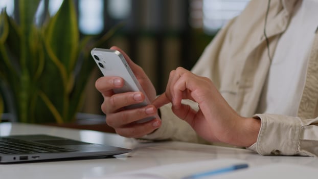 Close up of male hands typing mobile phone unrecognizable businessman African American man business worker using smartphone at table in office online internet chatting app searching internet addicted photo