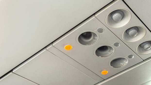 Illuminated buttons on an airplanes ceiling panel, evoking airborne odysseys, celebratory Flight Attendant Appreciation Day, aeronautical whimsy photo