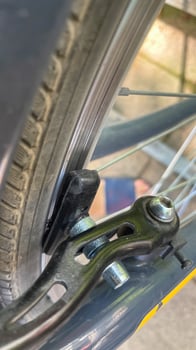 Tire and brake symphony in a metallic embrace, capturing Earth Days cycling dreams and the art of kinetic silence photo