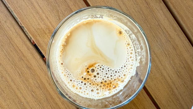 Effervescent latte topography swirls in a glass, invoking National Coffee Day zen, echoing hygge and artisan espresso craftsmanship photo