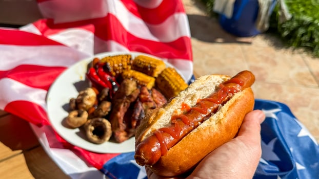 Patriotic picnic feast featuring juicy hot dogs and grilled corn evokes Independence Day nostalgia and Labor Day gatherings photo
