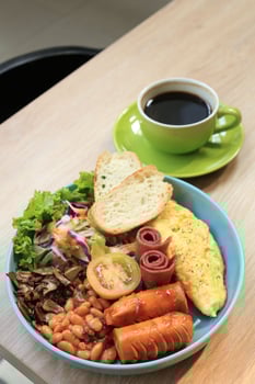 English Breakfast with Beans, Bacon, Egg Omelette, Salad, Bread, and Sausages. photo