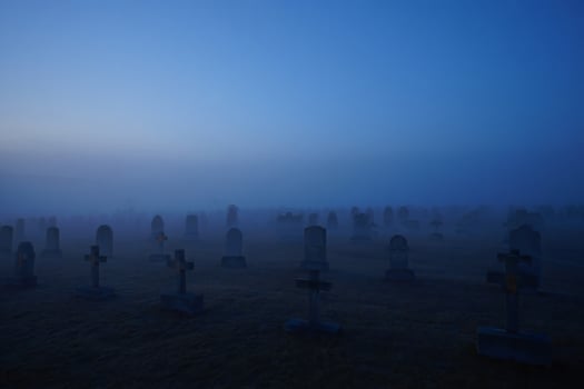 Halloween Background Mysterious Fog Shrouded Cemetery at Dawn Eerie Headstones and Crosses photo