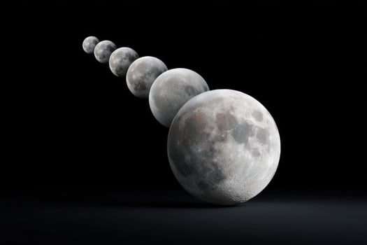 Sequence of grayscale moons showcasing phases against a black background photo