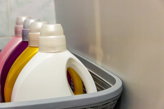 A basket of laundry detergents in a bathroom photo