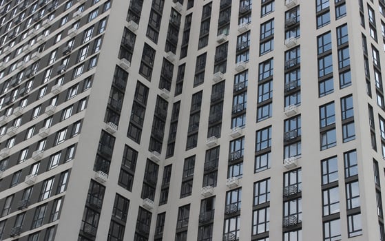 Facade of a modern high-rise building with cheap apartments and small balconies photo