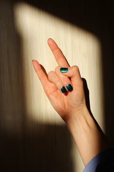 a hand showing a rock and roll sign or depicting the devil's horns. photo
