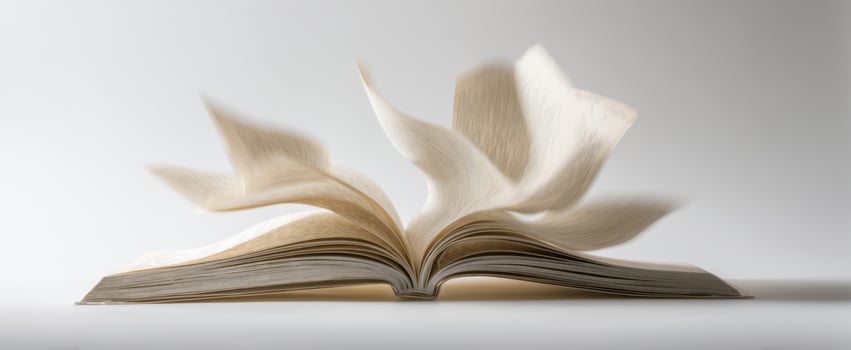 The book with pages fluttering in the air creating a dynamic motion effect. photo