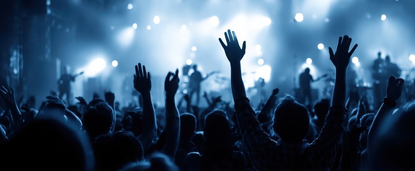 The enthusiastic crowd enjoying a vibrant live music concert under colorful lights photo