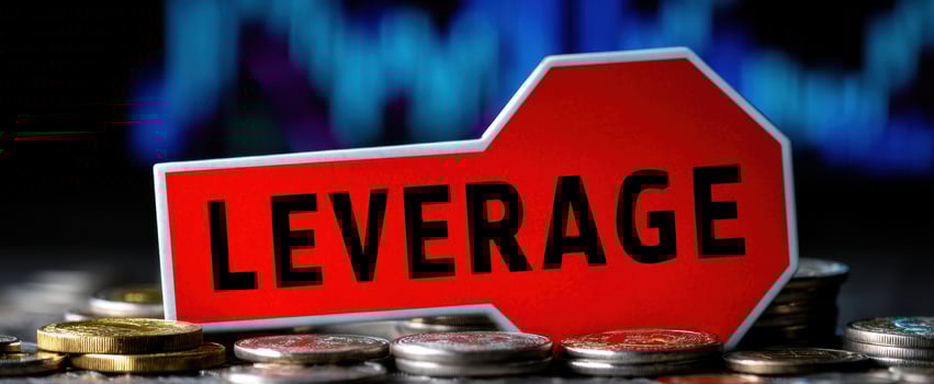 The Leverage Concept Highlighted in a Financial Context with Coins and Background Chart photo