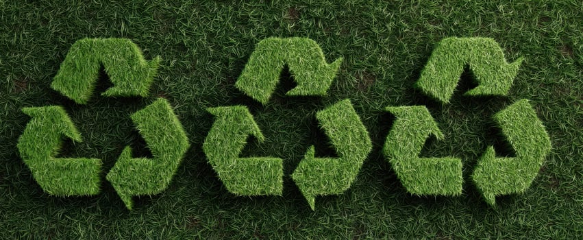 The green recycling symbol made of grass on a natural background. photo