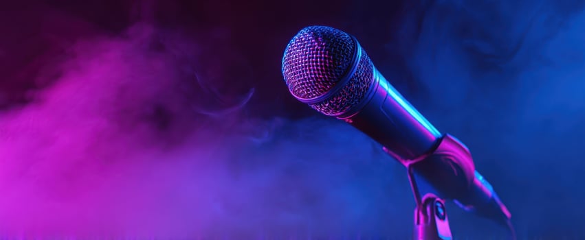 The vibrant microphone standing amidst colorful fog lighting up the stage. photo