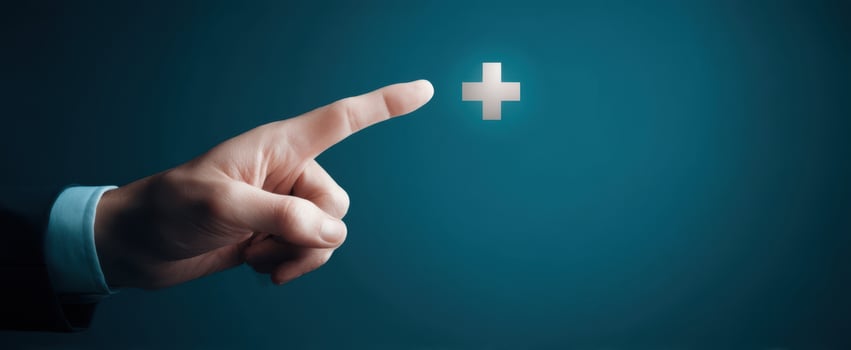 The hand reaching out to a glowing plus symbol on a blue background. photo