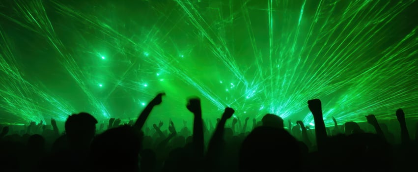 The vibrant crowd enjoying an electrifying laser show at a concert. photo