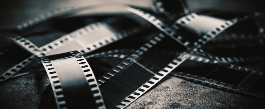 The artistic arrangement of black and white film strips on textured surface. photo
