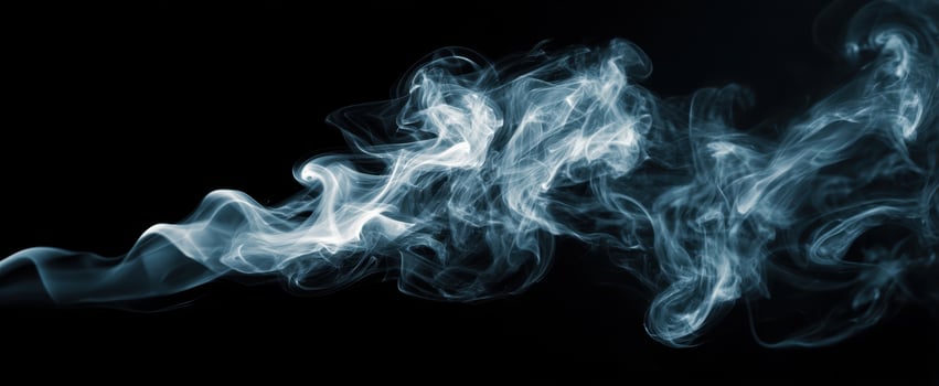 The ethereal dance of smoke against a black background. photo