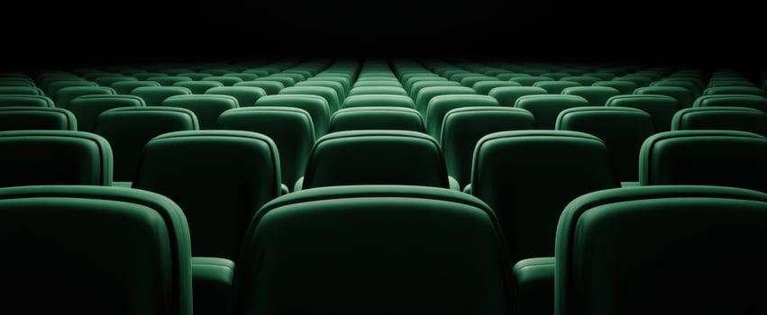 The serene rows of green movie theater seats awaiting audience enjoyment. photo