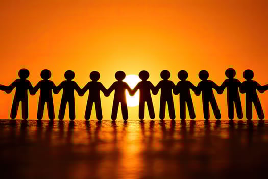 Silhouette figures linked, sunset background photo