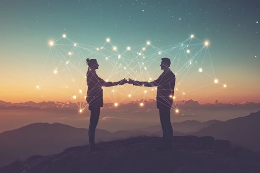 Two figures shaking hands amidst a network of lights against a mountain sunrise photo