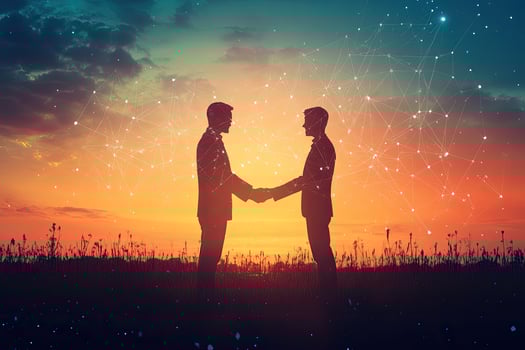 Two businessmen shaking hands at sunset photo
