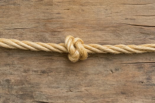 A tied rope on wooden planks photo