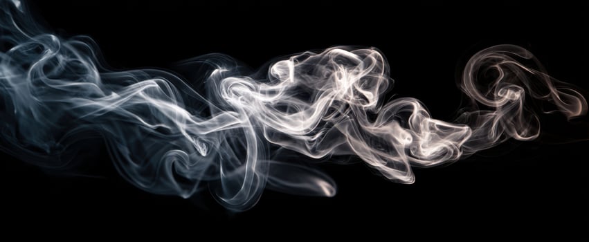 The delicate movement of smoke swirling elegantly in the darkness. photo