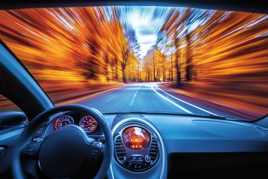 Automobile driving in autumn forest with motion blur photo