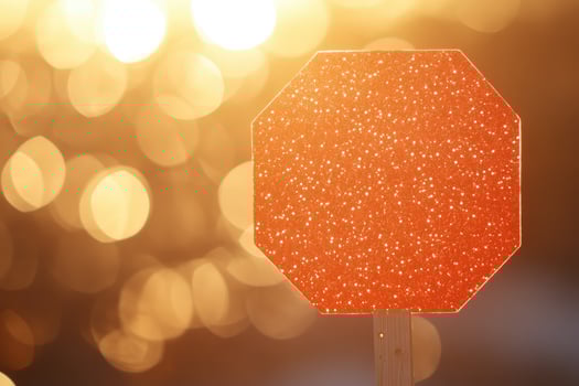 Octagonal stop sign, glitter finish, blurs of golden lights in background photo