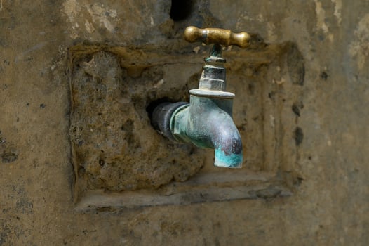 Old Bronze Water Tap in Outdoor Washbasin in Cyprus photo