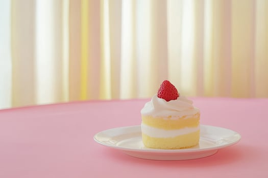 Delicate layered cake with a single strawberry photo