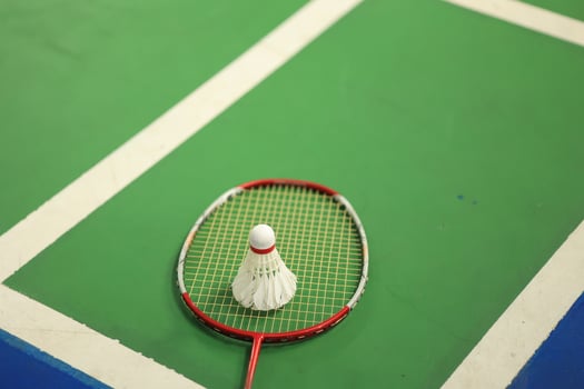Badminton Sport Equipments, Shuttlecocks and Rackets, on PV Floor of Indoor Badminton Court photo