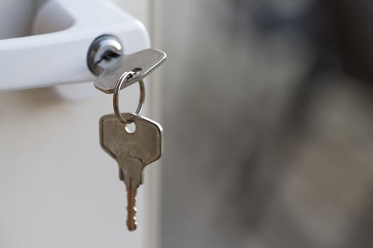 Key Inserted in Door Lock Close-Up photo