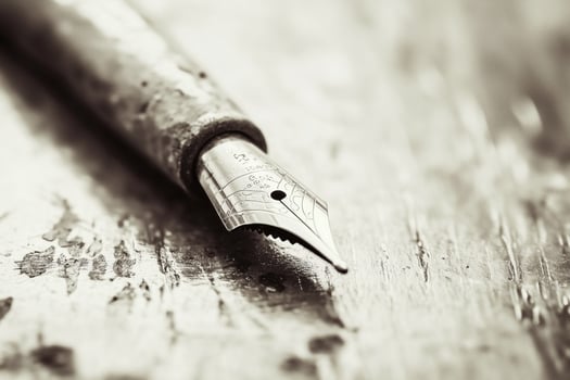 A close up of a pen on a wooden surface photo