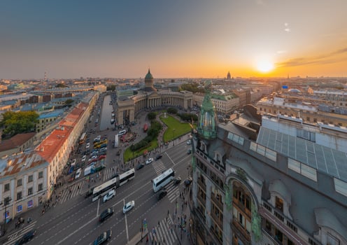 Drone view of Zinger House and Book House, fountain in front of Kazan Cathedral and Isaac cathedral at sunset, Griboyedov Canal, busy traffic along Nevsky avenue, rooftops, Russia, St.Petersburg photo