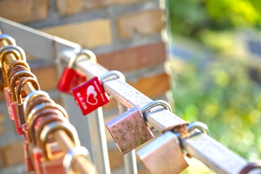 Many Colorful Love Locks on a Railing photo