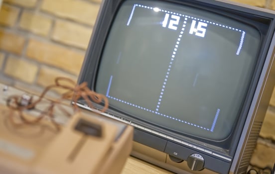 Vintage TV Displaying Classic Pong Game photo