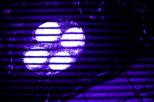 A close-up view of a four LED Spot, illuminated ultraviolet light at 50Hz creating a striking purple flicker effect photo