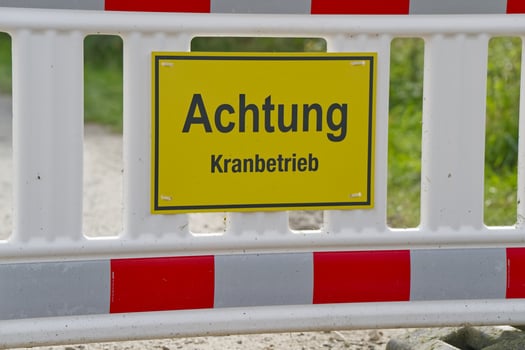 Caution Sign for Crane Operations at Construction Site photo