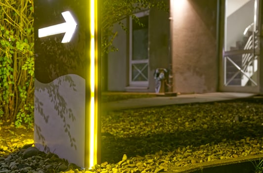 Illuminated Directional Sign at Night photo