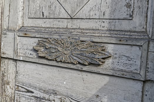 Ornate Weathered Wooden Door with Floral Carving photo